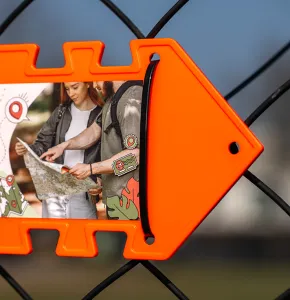 Neon orange Arrow Sign attached with black Cable Tie